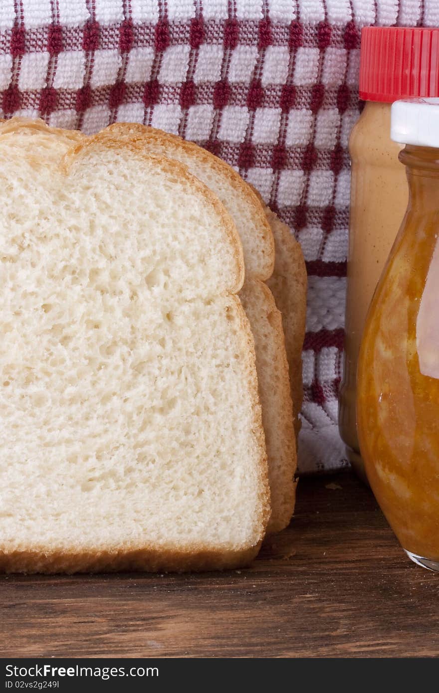 Yellow jam in bank and a white bread for a sweet sandwich. Yellow jam in bank and a white bread for a sweet sandwich.