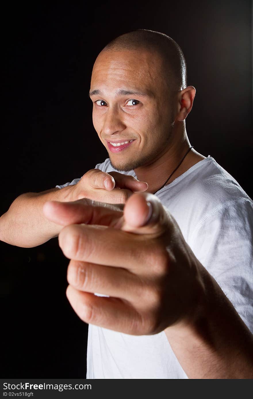 Young male filipino model over a black background is gesturing with his hand. Young male filipino model over a black background is gesturing with his hand.