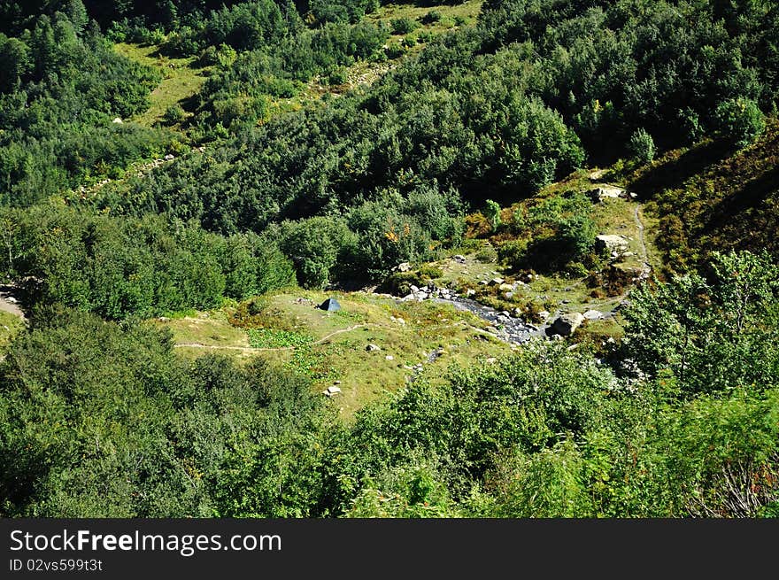 Small camping in the mountains near the forest and river