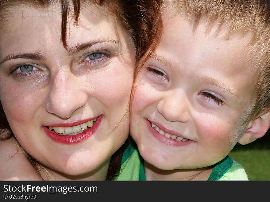 Face of the mother and son close up look at the camera smiling