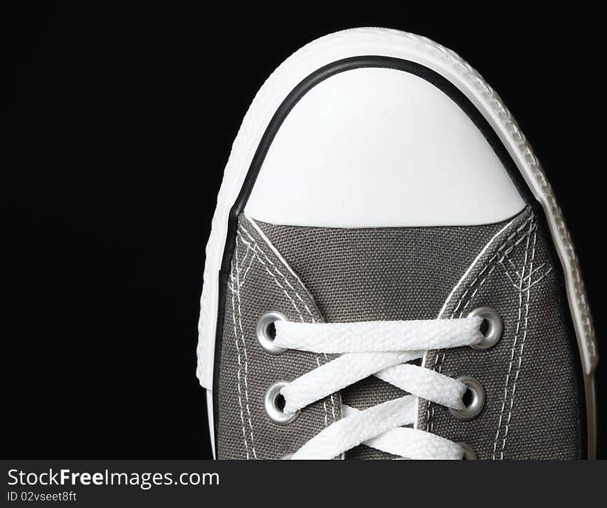 Gray sneakers classic youth footwear at black background