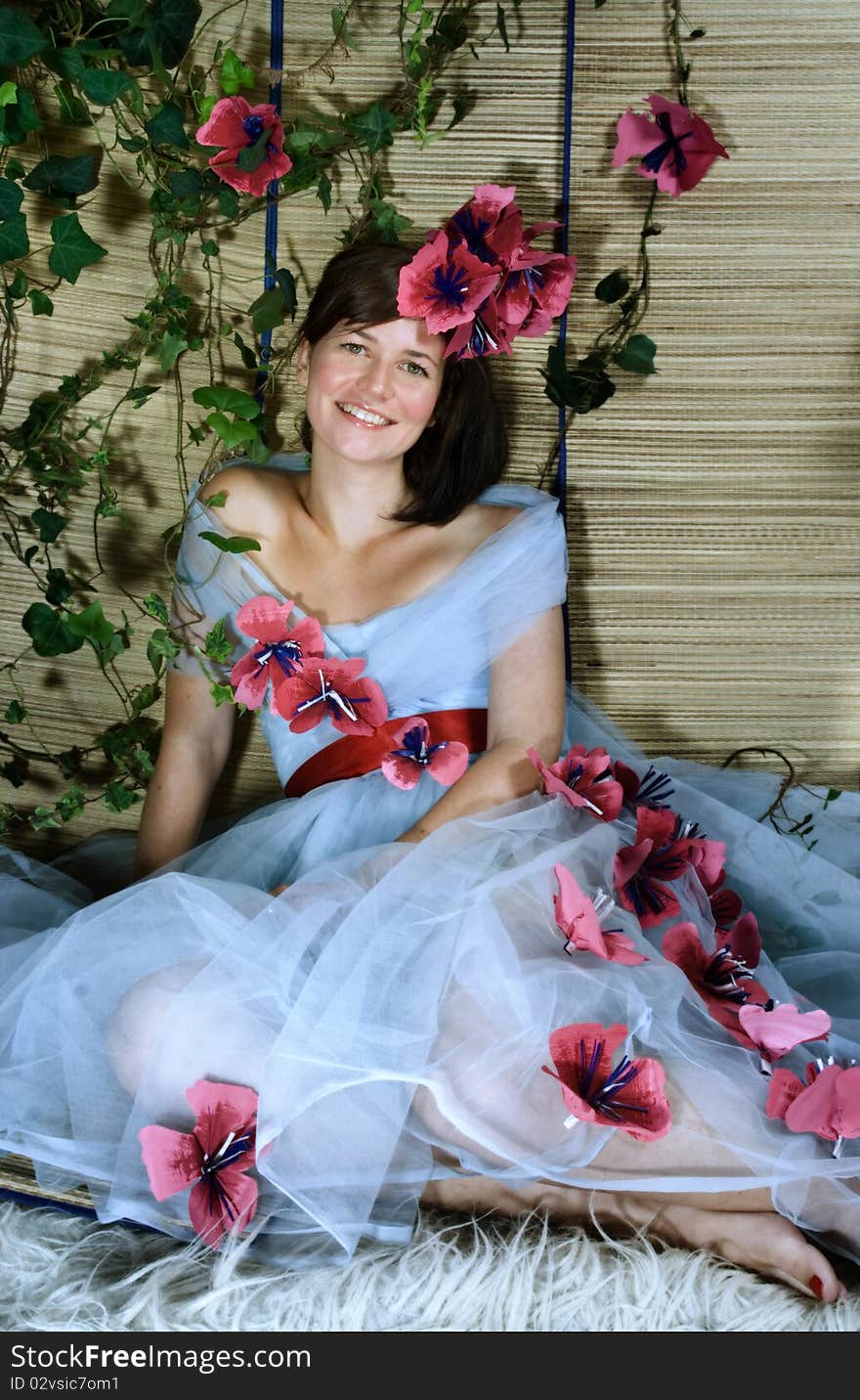 Young beautiful brunette with green eyes smiling in garden. Young beautiful brunette with green eyes smiling in garden