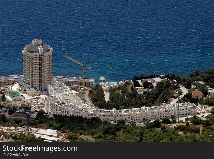 Luxury hotel on coastline with blue sea