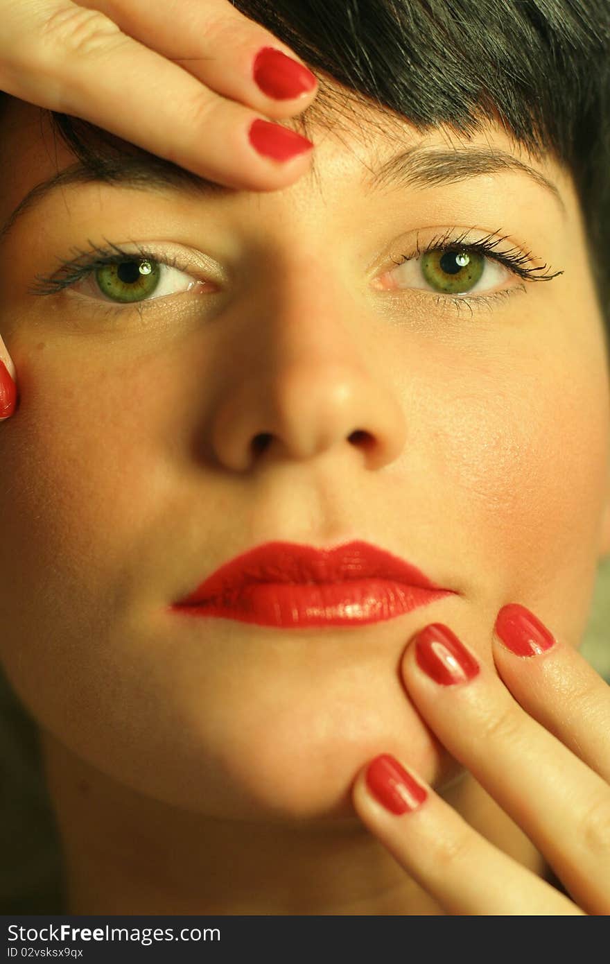 Closeup portrait of a beautiful woman with red lips and red nails. Closeup portrait of a beautiful woman with red lips and red nails