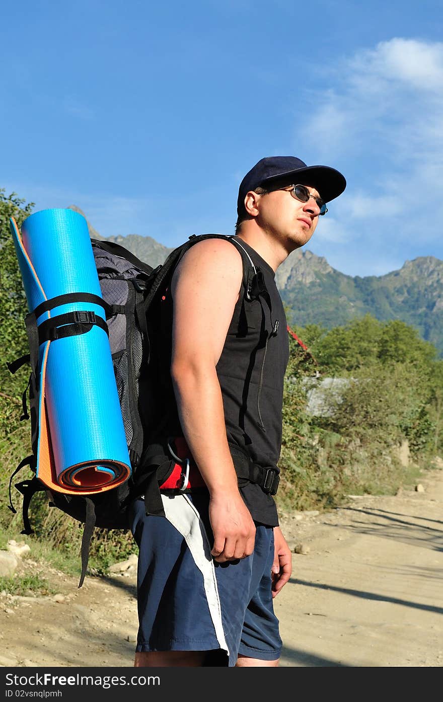 Tourist with a large backpack is a high mountain