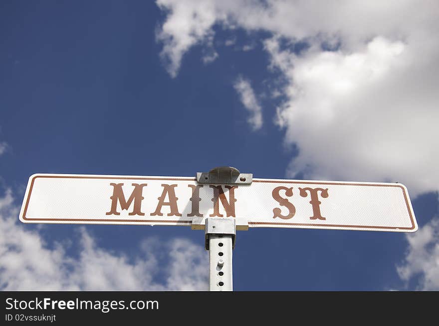 Main St American road sign with sunny bright cloud scape background