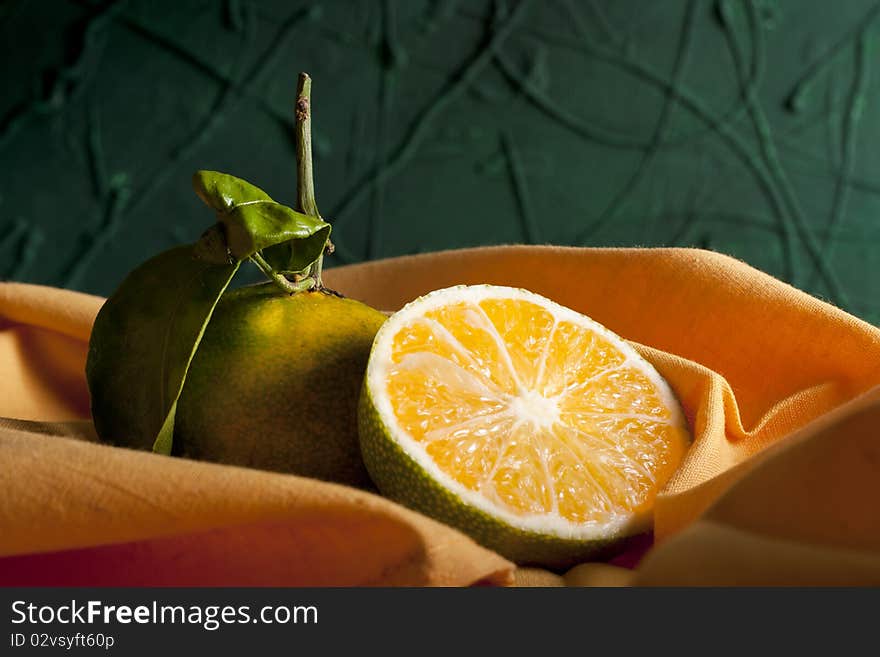 Two Green Miyagawa Mandarins with Orange Napkin