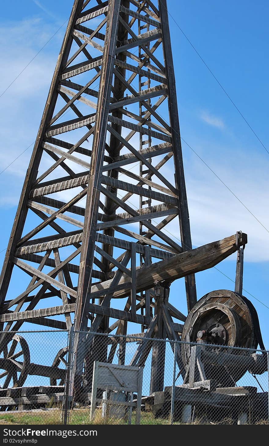 Wooden vintage oil rig in the field. Wooden vintage oil rig in the field.