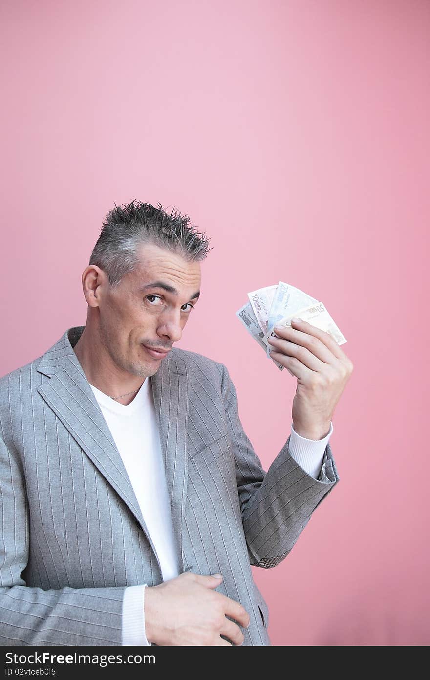 Man showing greed in handling money. Man showing greed in handling money