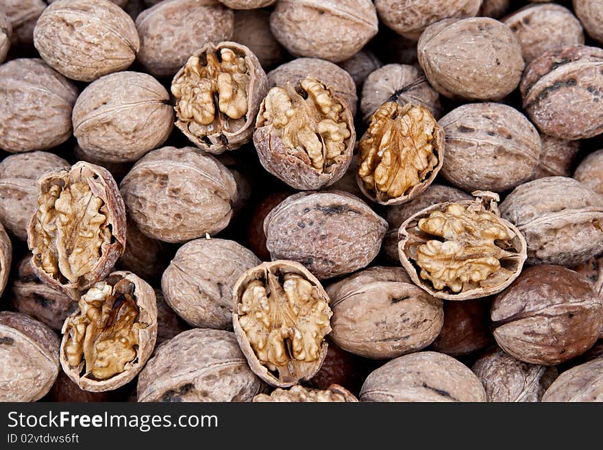 Brown raw walnuts textured background