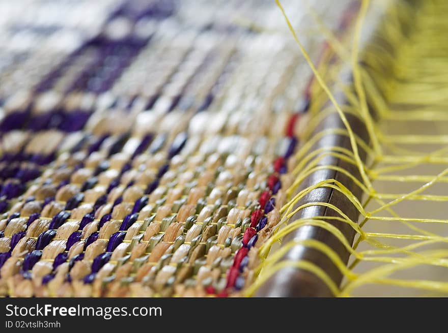 Detail of straw mat during production on a weave. Very shallow depth of field. Detail of straw mat during production on a weave. Very shallow depth of field.