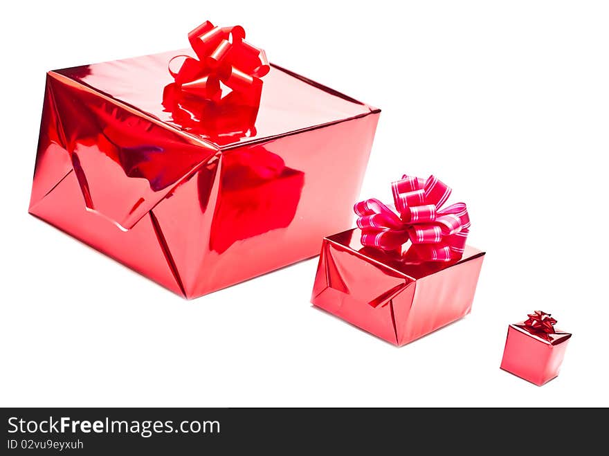 Row from red christmas gifts boxes with bows. Isolated on white background. Row from red christmas gifts boxes with bows. Isolated on white background