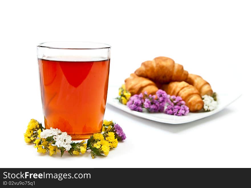 Tea and croissant with flowers design isolated on white