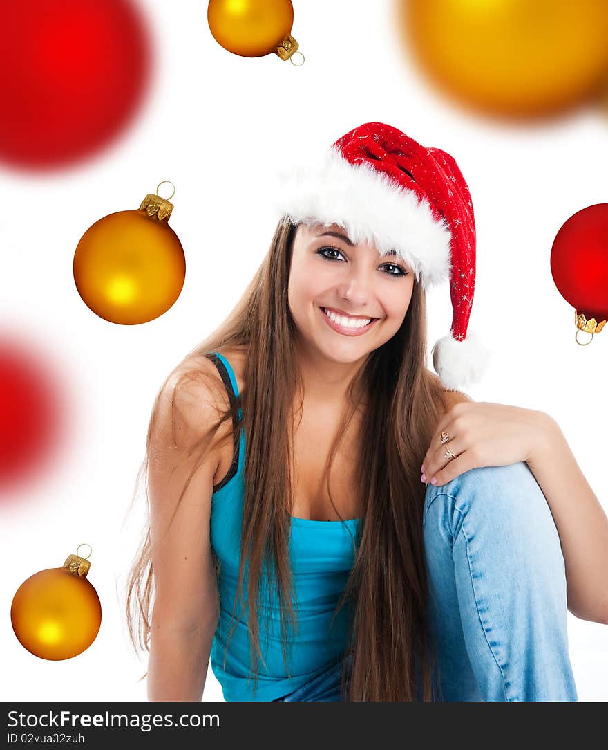 Attractive young women in santa claus hat on a spheres background. Attractive young women in santa claus hat on a spheres background