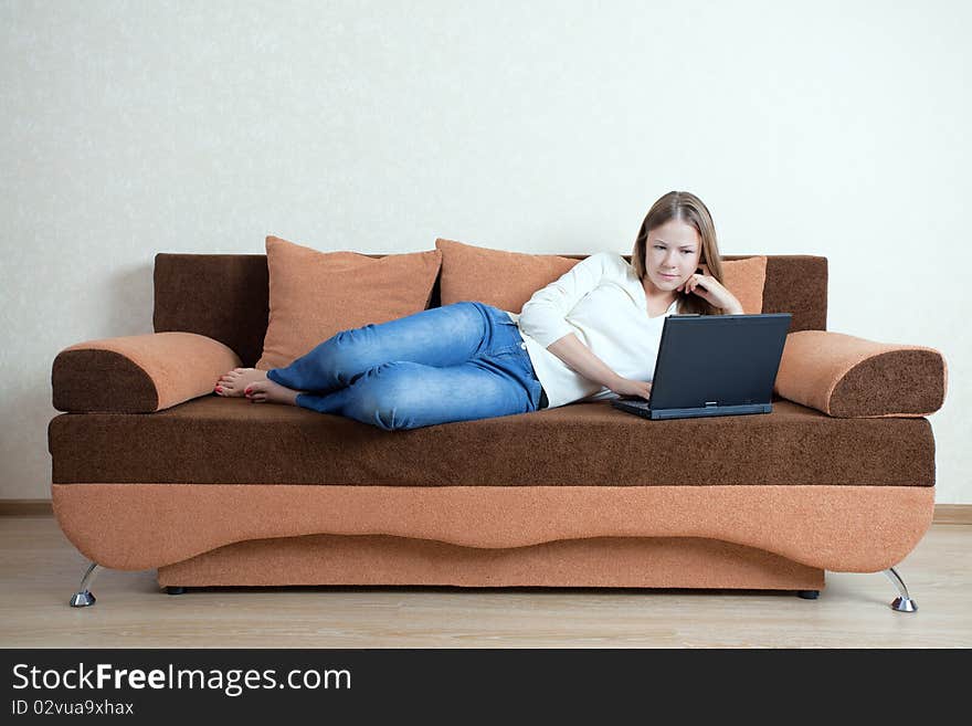 Woman With Laptop On The Sofa