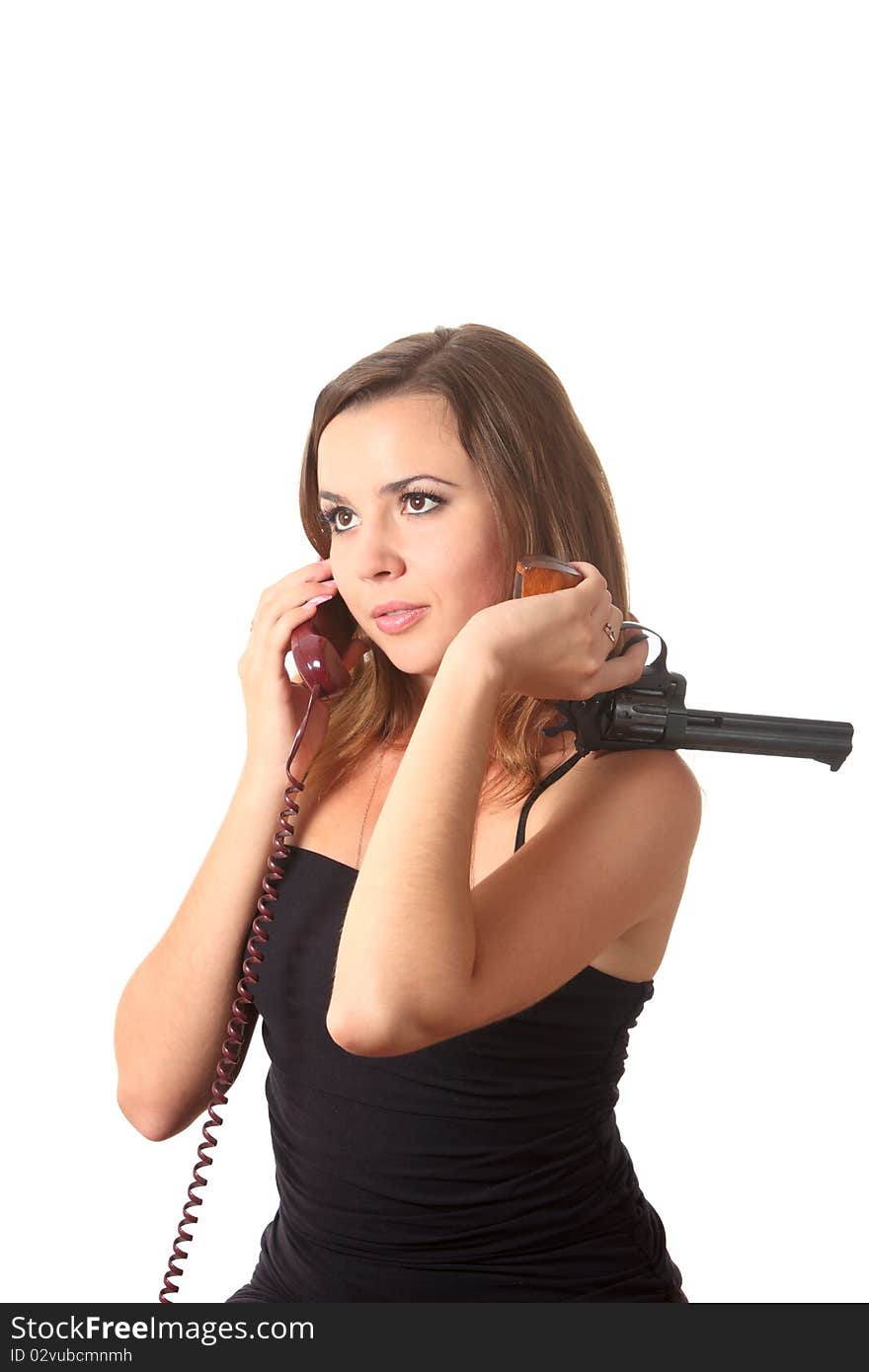 A young girl with revolver speak by phone on the white isolation background. A young girl with revolver speak by phone on the white isolation background