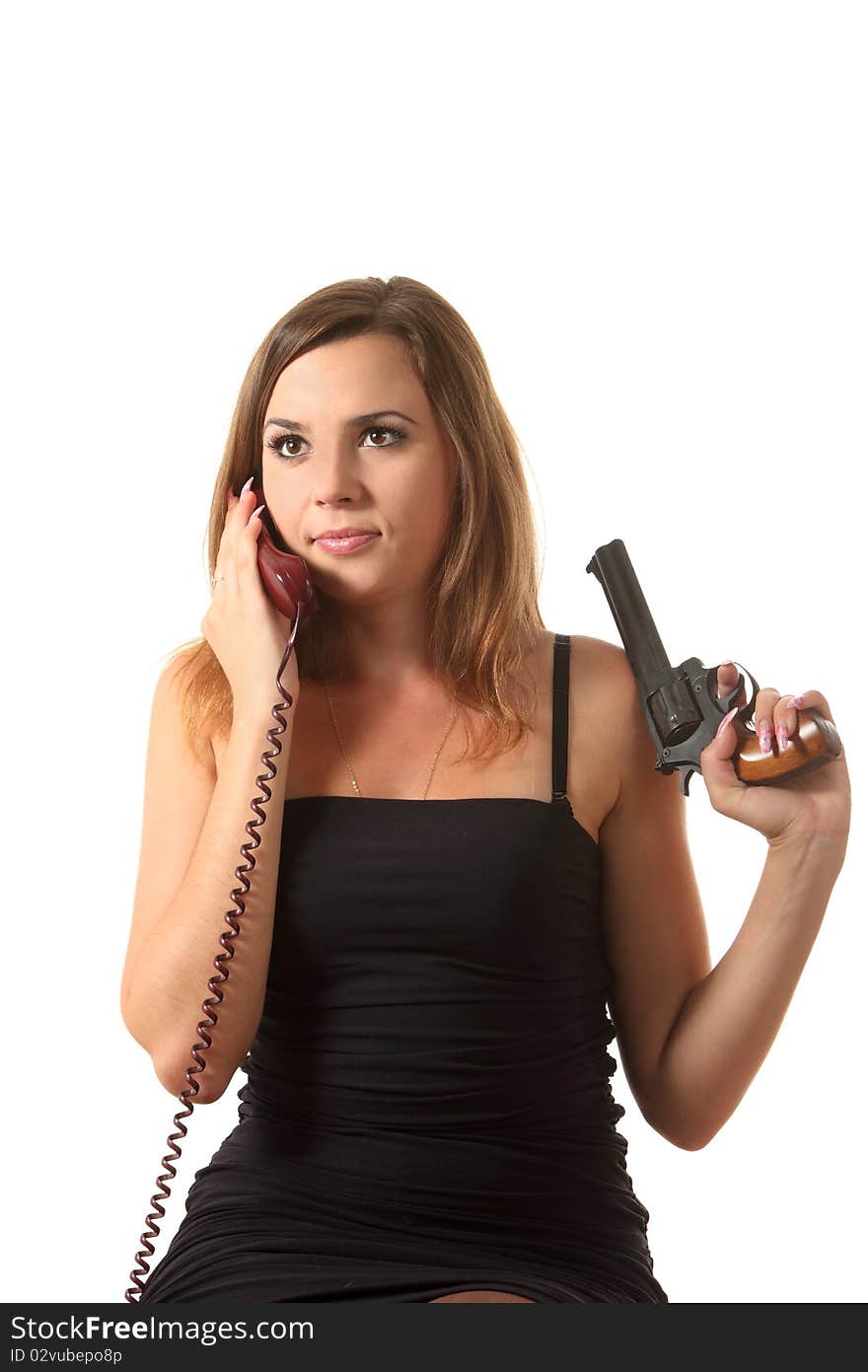 A young girl with revolver speak by phone on the white isolation background. A young girl with revolver speak by phone on the white isolation background