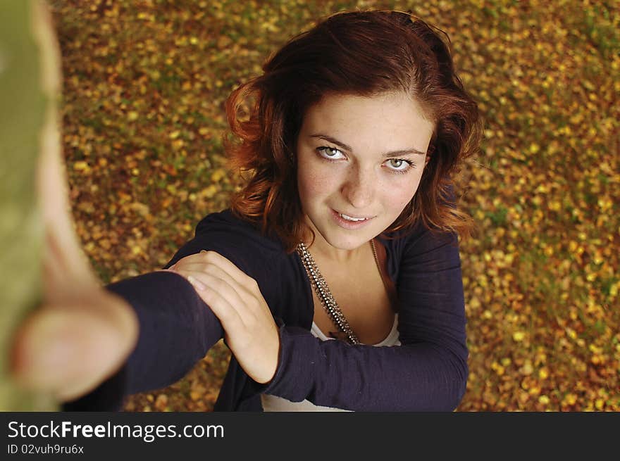 Girl in autumn orange leaves. Outdoor.