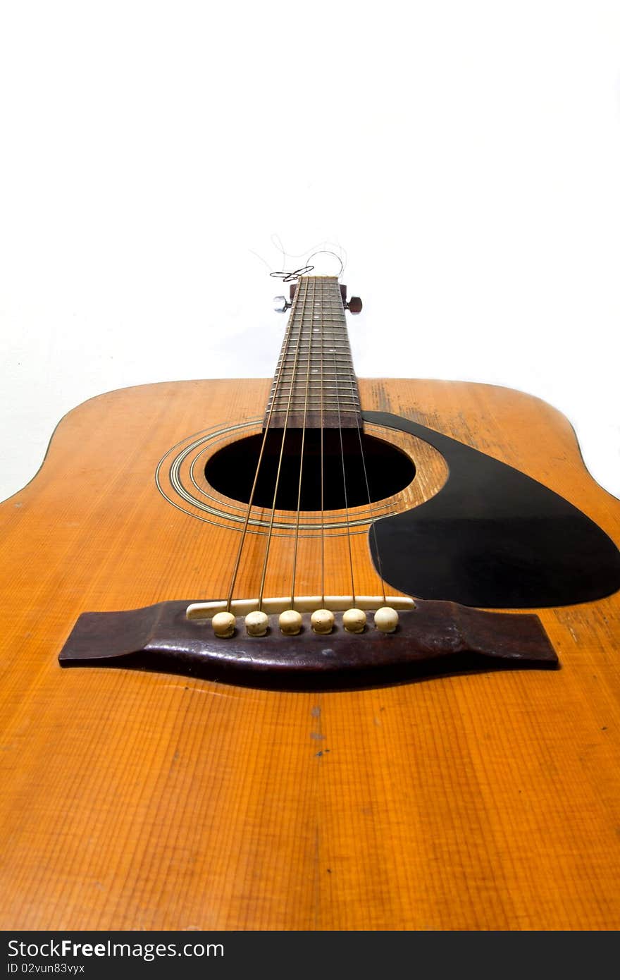 Wooden acoustic guitar isolated on white background. Wooden acoustic guitar isolated on white background.