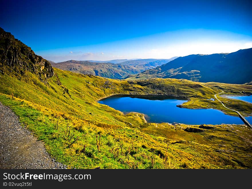 View of beautiful welsh mountain range with lake. View of beautiful welsh mountain range with lake