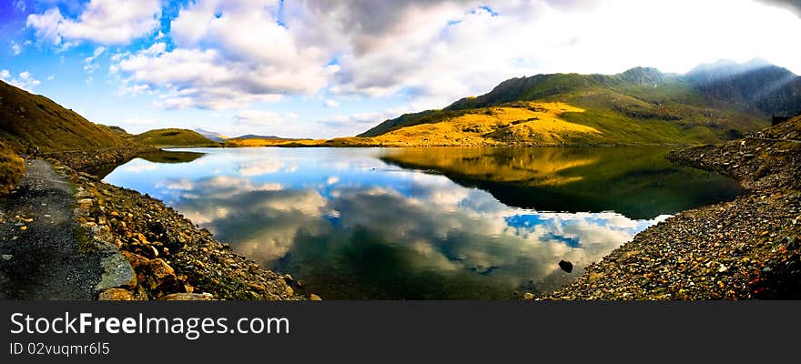 View of beautiful welsh mountain range with reflection in the lake. View of beautiful welsh mountain range with reflection in the lake