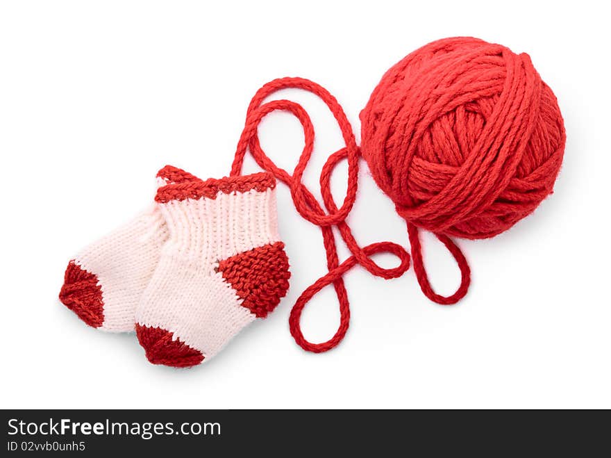 Isolated red skein and knitted socks