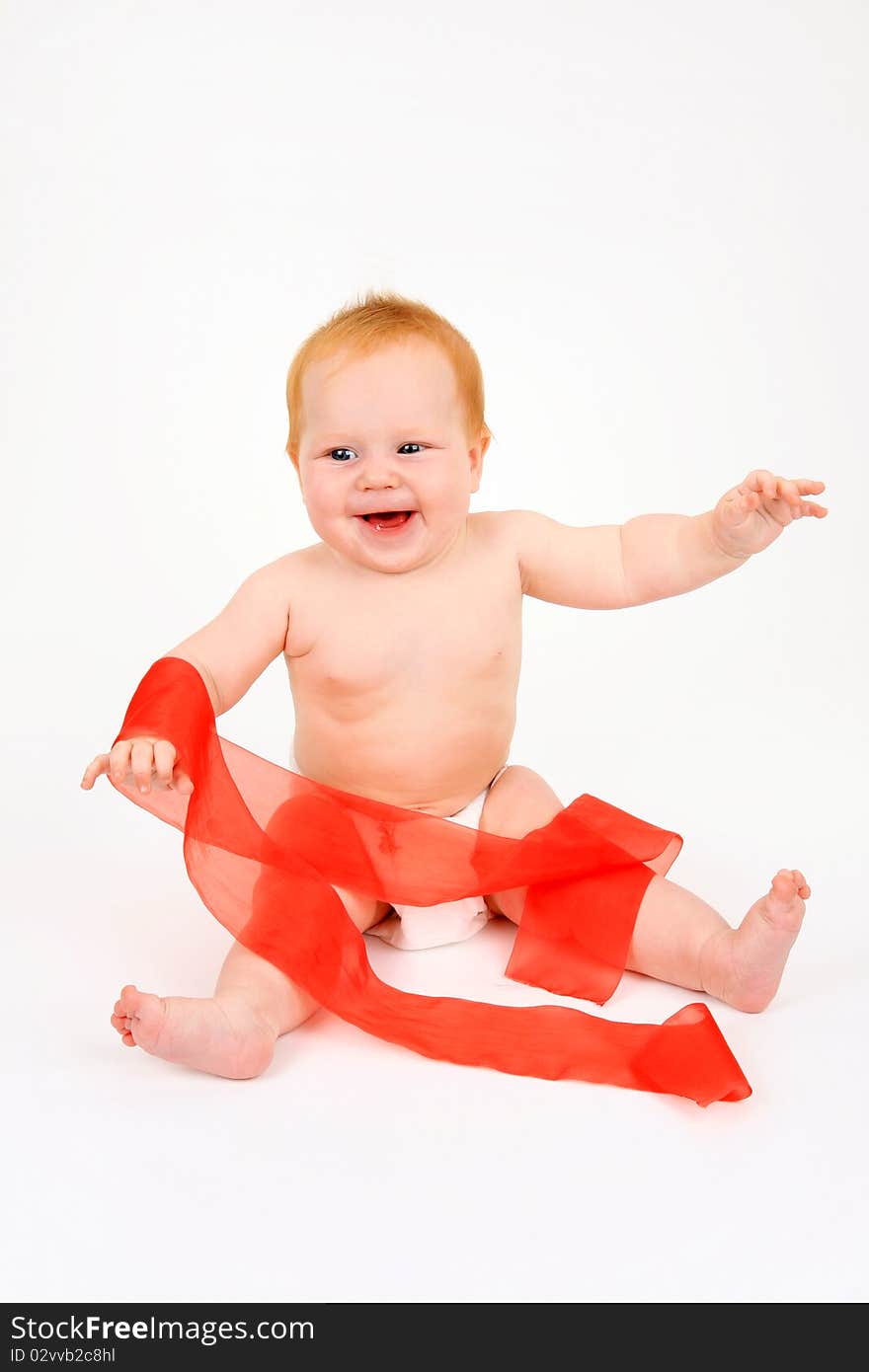 The child playing with a red ribbon on a white background