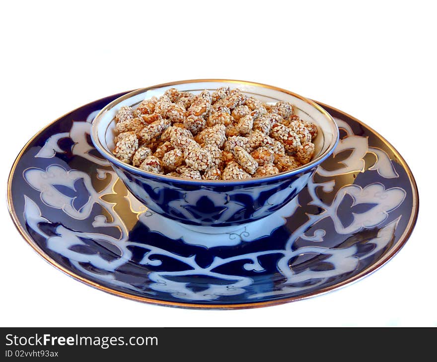 Oriental Sweets - peanuts with sesame on a plate Uzbek