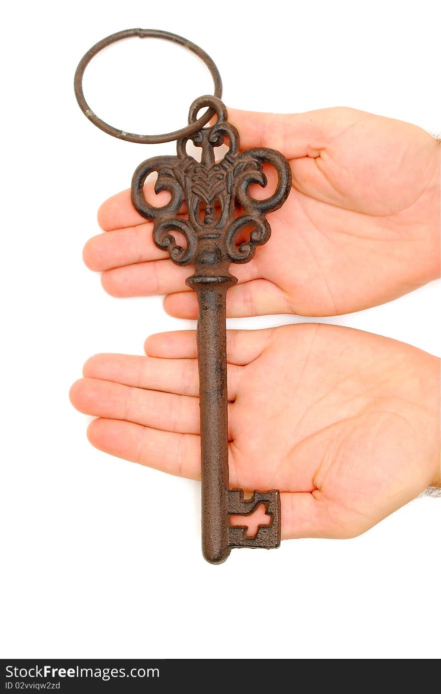 Rustic old key in hands on white background. Rustic old key in hands on white background