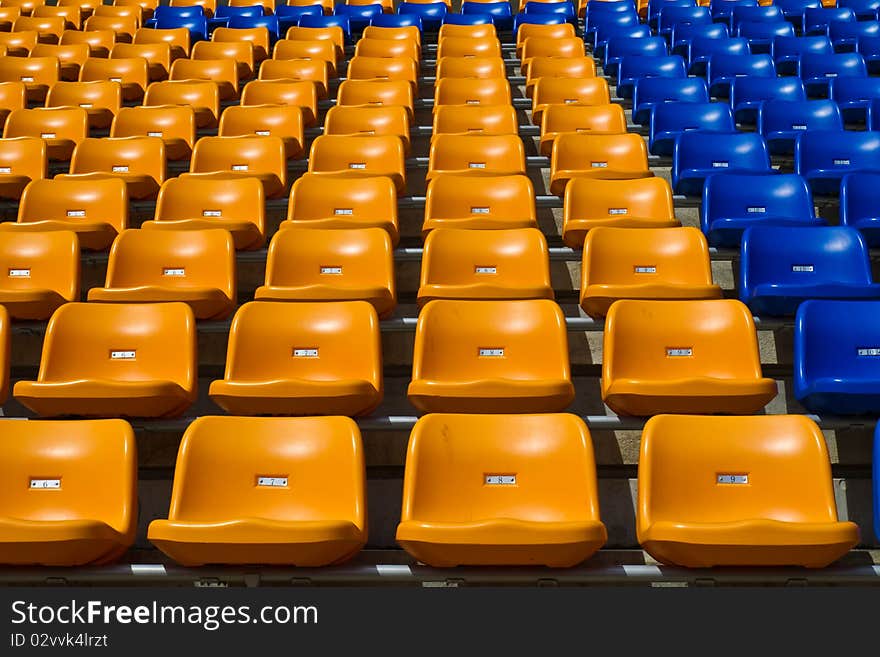 Rows of orange bright colour seat at the stadium unipue. Rows of orange bright colour seat at the stadium unipue.