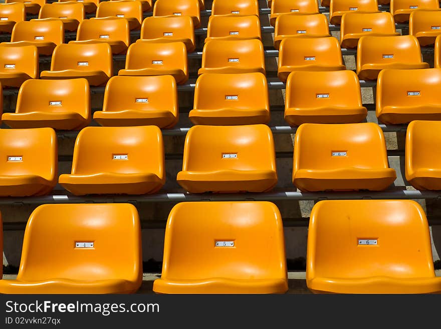 Rows of orange bright colour seat at the stadium unipue. Rows of orange bright colour seat at the stadium unipue.