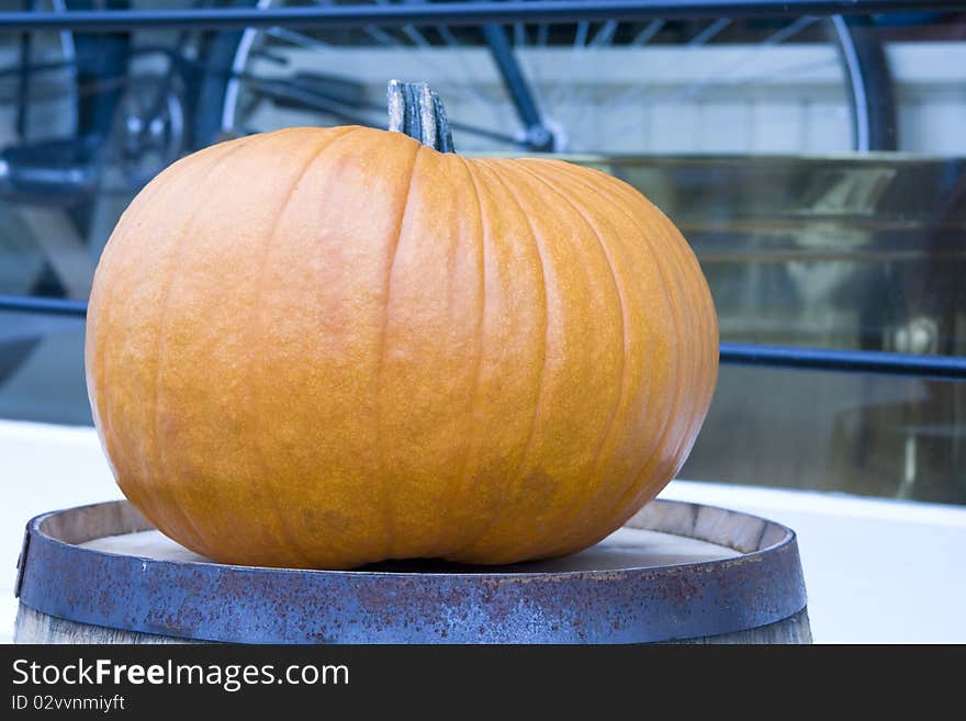 Isolated picture of a pumpkin sitting on a barrel