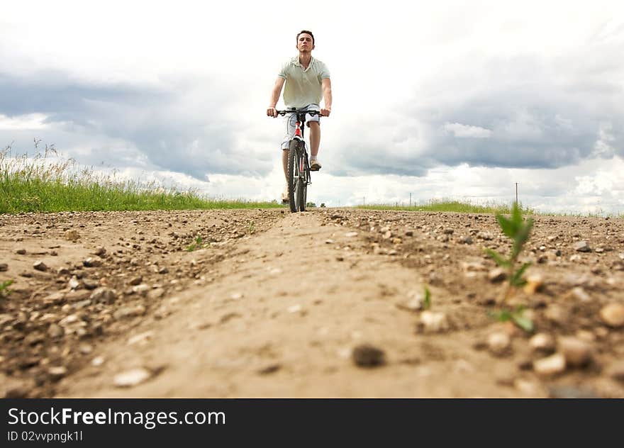 Man on bicycle, travels across the field