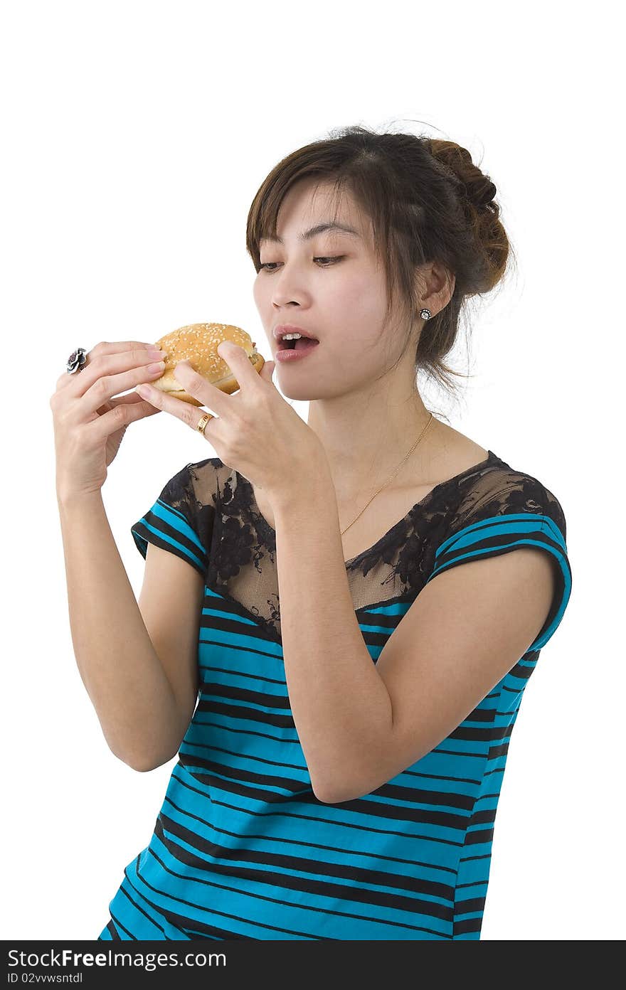 Pretty woman enjoying a hamburger over white background. Pretty woman enjoying a hamburger over white background