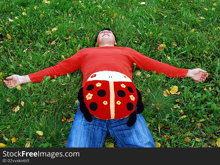 Photo of the young man having a rest on a grass