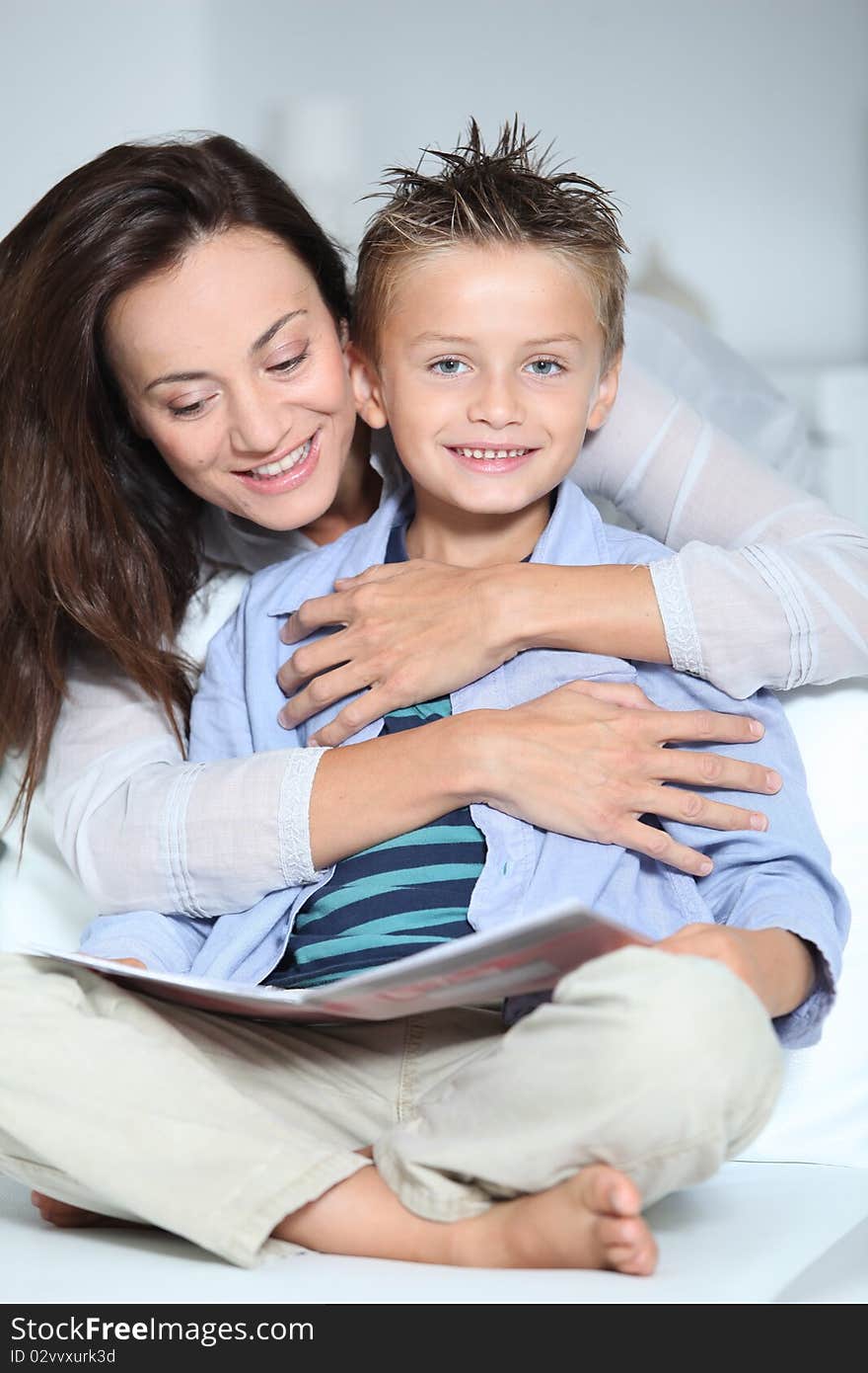 Mother and child reading book at home