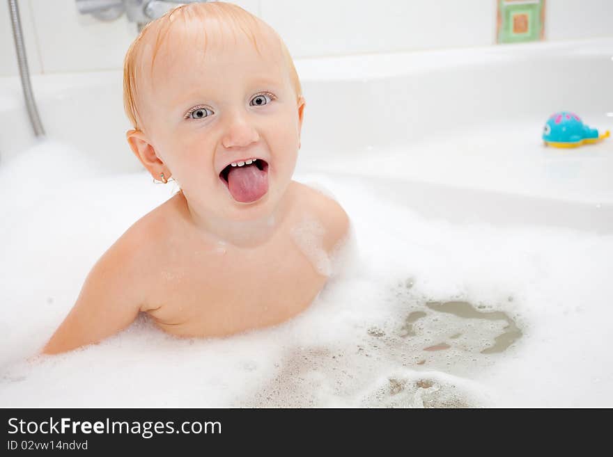 A baby girl in a bathtub