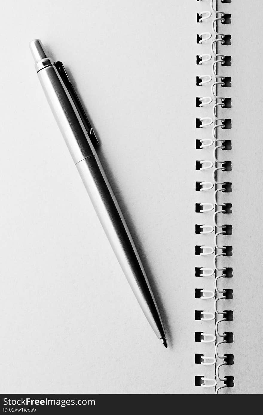 The ballpoint pen and binder of notepad. The ballpoint pen and binder of notepad