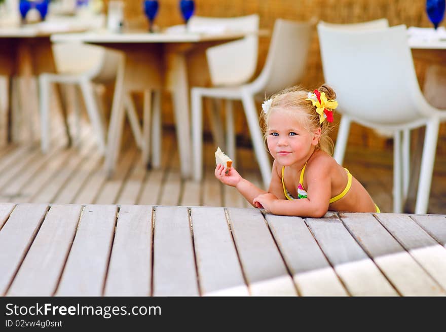 Cute Little Girl Sits Have A Snack Outdoor