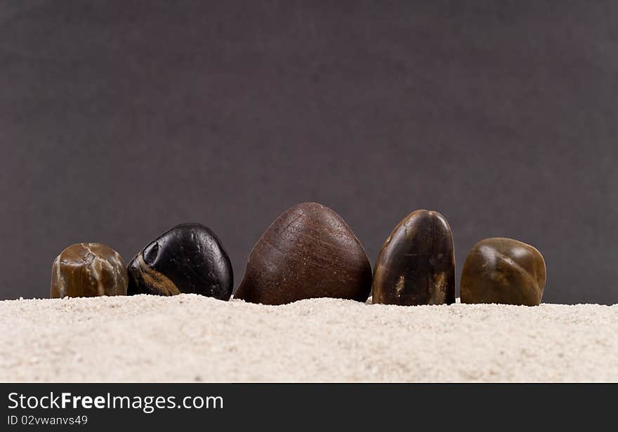 Smooth Stones Protruding From Sand. Smooth Stones Protruding From Sand