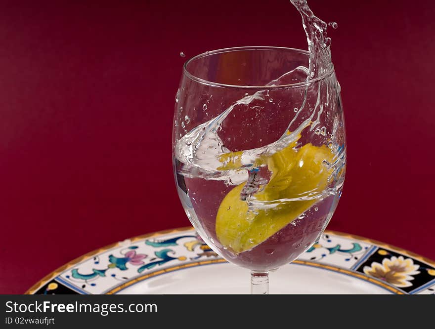 Apple Slice Dropped in Glass of Water. Apple Slice Dropped in Glass of Water