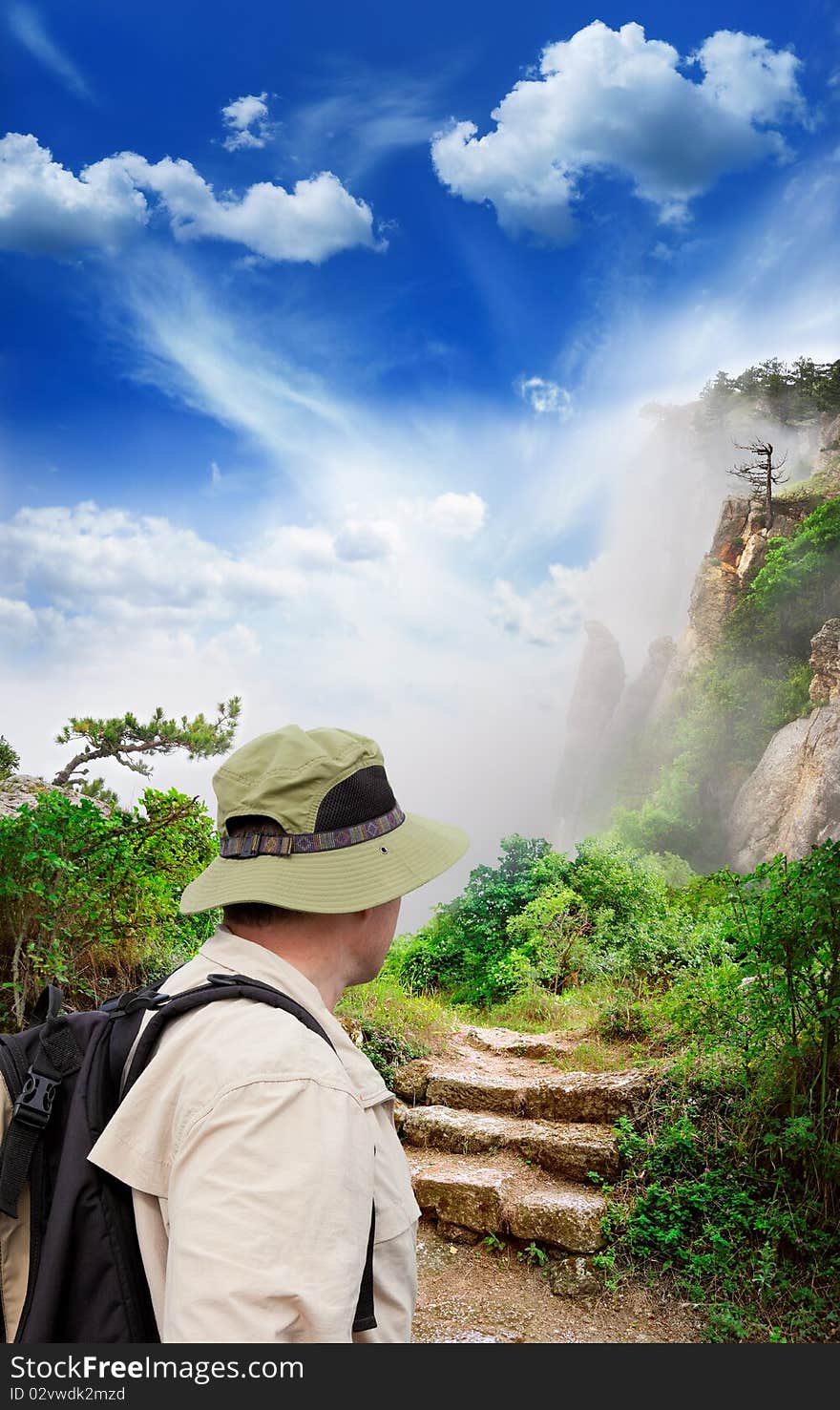 Figure of a tourist looking into magnificent view of the mountains. Figure of a tourist looking into magnificent view of the mountains