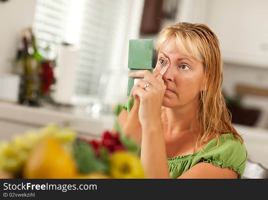 Blonde Woman Applying Her Makeup in Her Bathroom.