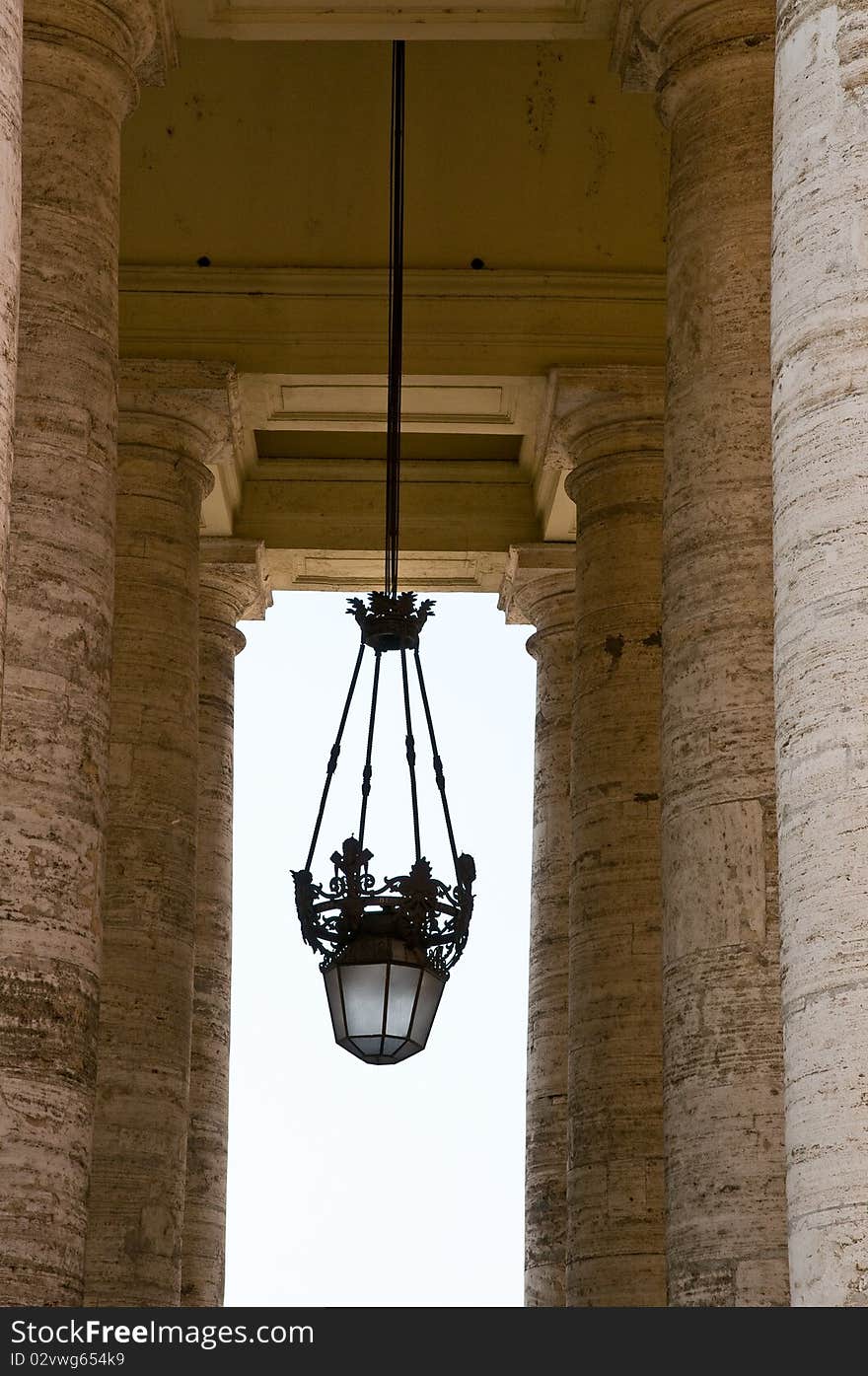 Some pillars and a chandelier at the st. peters square in rome. Some pillars and a chandelier at the st. peters square in rome