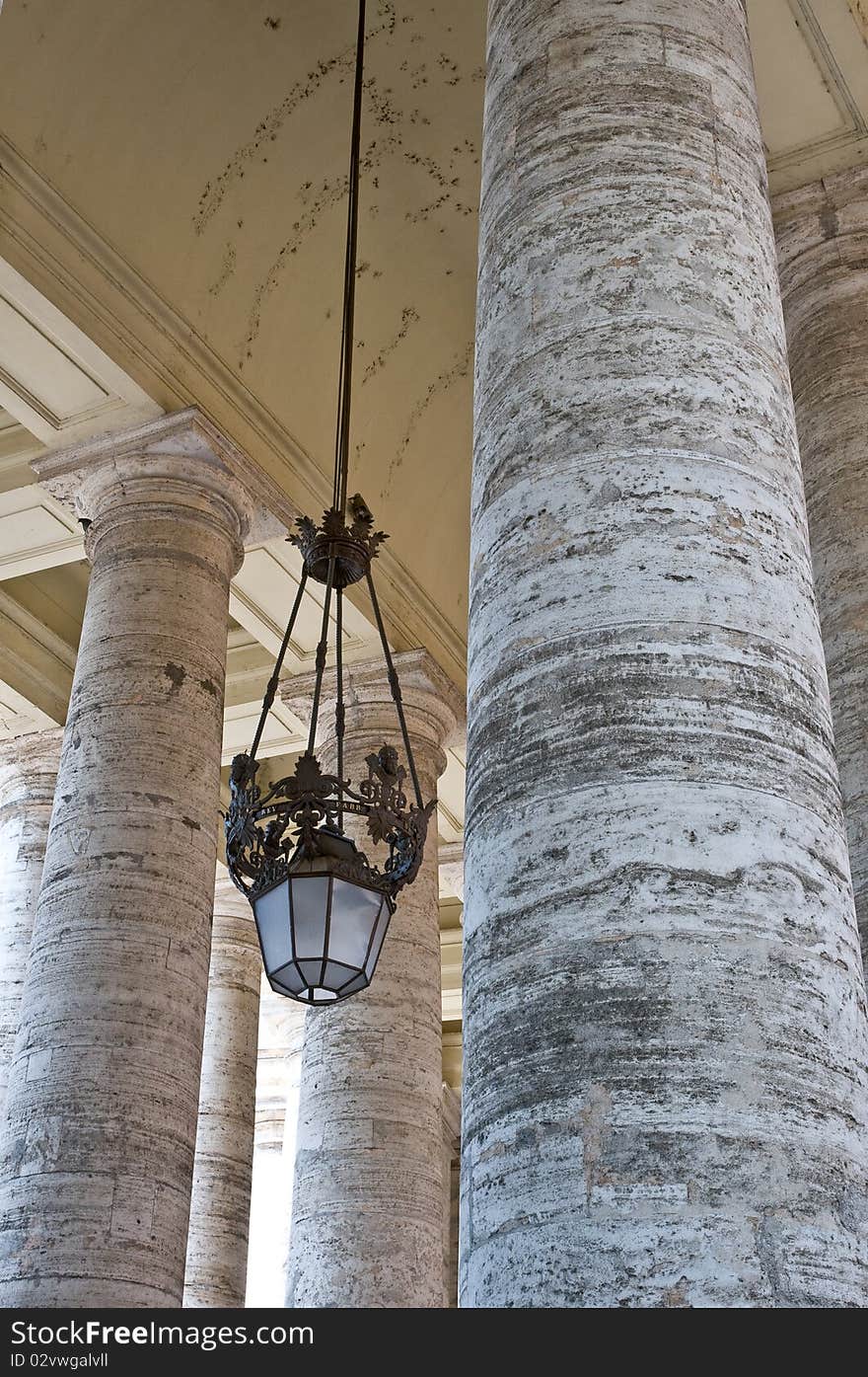 Some pillars and a chandelier at the st. peters square in rome. Some pillars and a chandelier at the st. peters square in rome