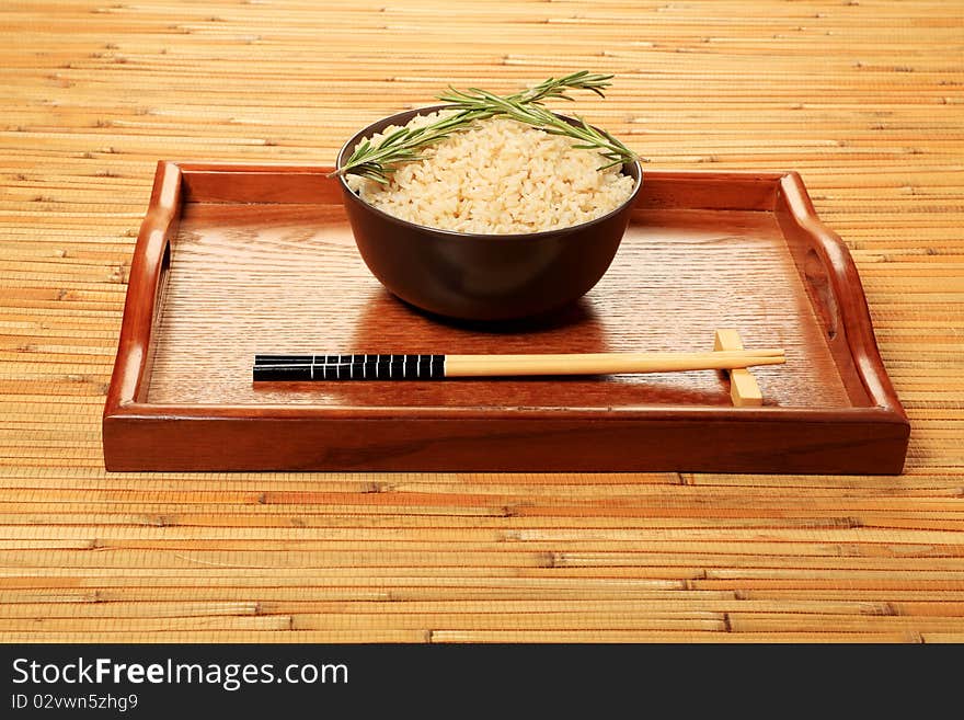 Steamed long rice in a brown bowl with chopsticks. Steamed long rice in a brown bowl with chopsticks.