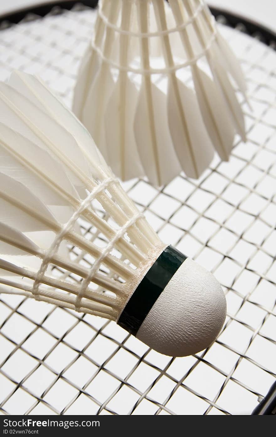 Close-up of badminton shuttlecocks on the racket