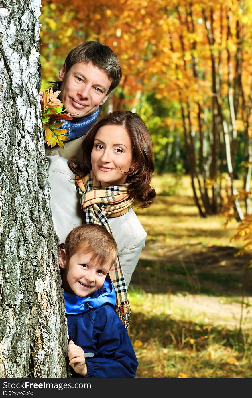 Happy family walking at the autumn park. Happy family walking at the autumn park.