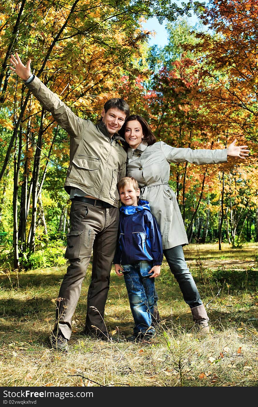 Happy family walking at the autumn park. Happy family walking at the autumn park.