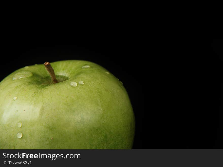 Delicious fresh green apple isolated on black